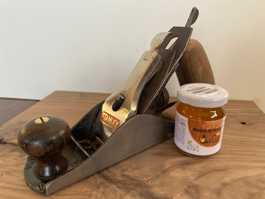 Sample size bottle of Livos next to a hand plane for size